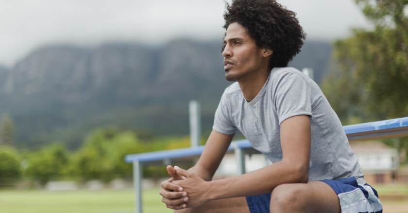Man sitting on bleachers in park